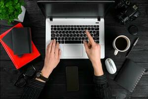 Overhead view of businesswoman working at computer in office photo