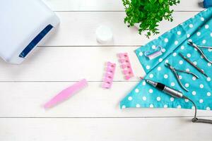 Different Beauty and Personal Care Hardware pedicure and manicure Feet Hand Nail tools and Accessories on white placed on table. photo