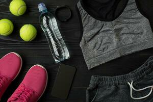 Sports accessories for fitness on the wooden floor. Healthy lifestyle concept. photo