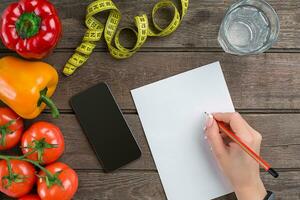 Concept diet, slimming plan with vegetables top view mock up photo