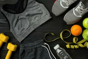 Sports accessories for fitness on the wooden floor. Healthy lifestyle concept. photo