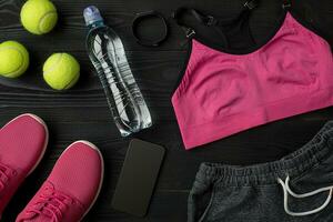 Workout plan with fitness food and equipment on dark background, top view photo