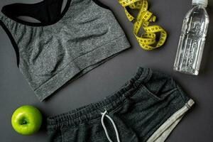 Workout plan with fitness food and equipment on gray background, top view photo