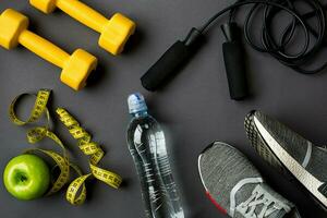 Workout plan with fitness food and equipment on gray background, top view photo