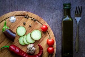 Healthy eating, vegetarian food. Raw eggplant prepared for frying in a frying pan with spices in olive oil photo