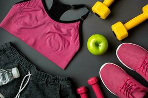 Workout plan with fitness food and equipment on gray background, top view photo