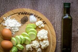 Fresh vegetables ready for roast. Top view. Wooden background photo