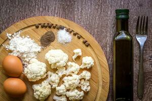 Healthy eating, vegetarian food. Raw cauliflower prepared for frying in a frying pan with spices in olive oil photo