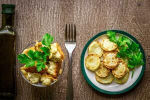 Cauliflower and zucchini baked in batter on a wooden background. photo