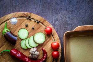 Healthy eating, vegetarian food. Raw eggplant prepared for baking in the oven with spices in olive oil photo