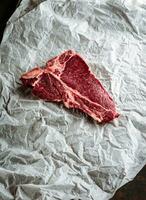 Raw meat Ribeye steak entrecote on wooden background photo