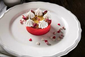 Caramel cheesecake with cream and flowers on the wooden background photo