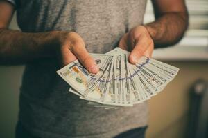 A man holds dollars in his hands photo