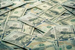 Lot of one hundred dollar bills close-up background photo