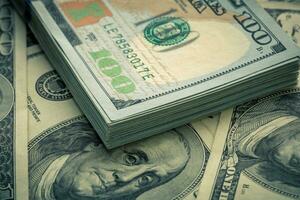 Lot of one hundred dollar bills close-up background photo