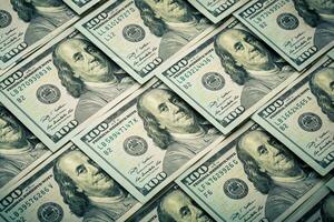 Lot of one hundred dollar bills close-up background photo