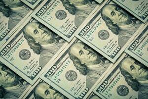 Lot of one hundred dollar bills close-up background photo