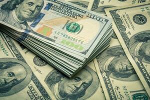 Lot of one hundred dollar bills close-up background photo