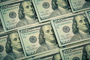Lot of one hundred dollar bills close-up background photo