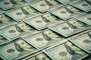 Lot of one hundred dollar bills close-up background photo