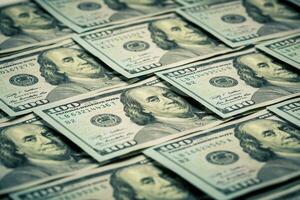 Lot of one hundred dollar bills close-up background photo