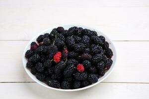 mulberry in white plate, top view photo