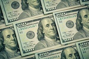 Lot of one hundred dollar bills close-up background photo