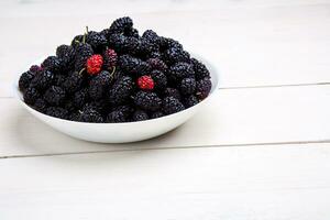 mulberry in white plate, top view photo