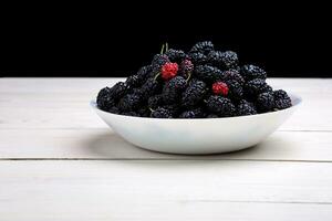 mulberry in white plate, top view photo