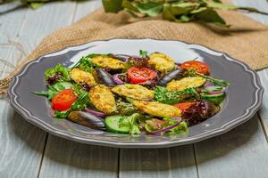 Fresh vegetable salad, healthy food, organic cucumbers, mussels, tomatoes and salad leaves photo