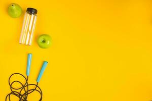 Top view of Skipping rope on yellow background photo