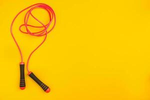 Top view of Skipping rope on yellow background photo