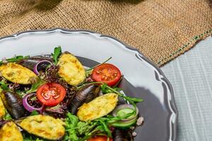 Fresh vegetable salad, healthy food, organic cucumbers, mussels, tomatoes and salad leaves photo