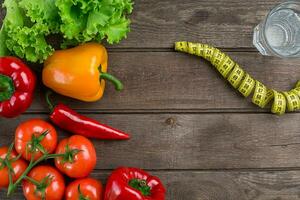 Fitness concept with vegetables. Fitness motivation with centimeter. Fitness motive. Pepper. photo