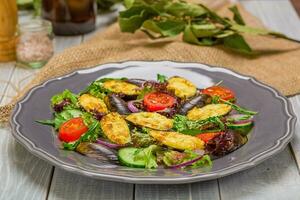 Fresh vegetable salad, healthy food, organic cucumbers, mussels, tomatoes and salad leaves photo