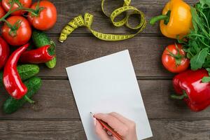 Concept diet, slimming plan with vegetables top view mock up photo