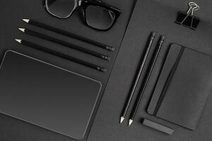 Blank notepad with clips, pens and glasses flat lay. photo