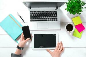 Overhead view of businesswoman working at computer in office photo