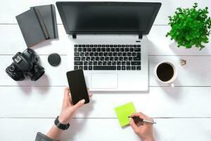 Overhead view of businesswoman working at computer in office photo