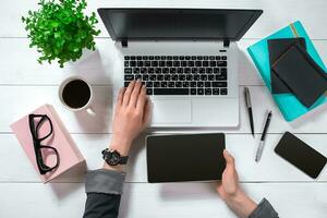 Overhead view of businesswoman working at computer in office photo