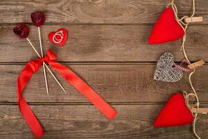 Valentines day background with handmade toy hearts and ring over wooden table photo