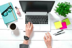 Overhead view of businesswoman working at computer in office photo