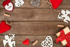 Valentine's day background with heart shapes on wooden table photo