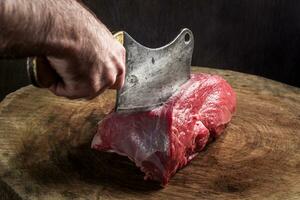 Juicy raw beef steak on wooden table photo