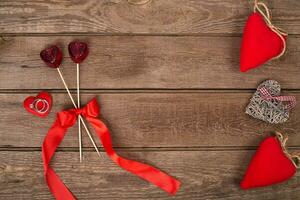 hearts and ring on wooden background. Valentines day photo