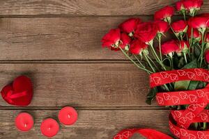 Red roses on wooden background. photo