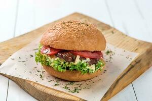 Close-up of home made burger on wooden board photo