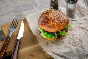 Burger on the table with devices photo