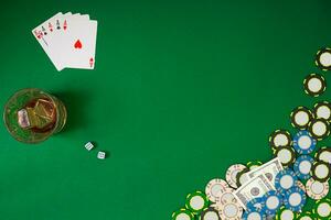 Set to playing poker with cards and chips on green table, top view photo