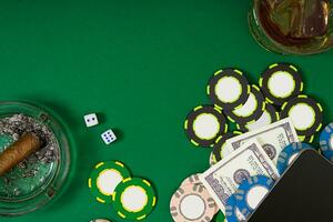 Set to playing poker with cards and chips on green table, top view photo